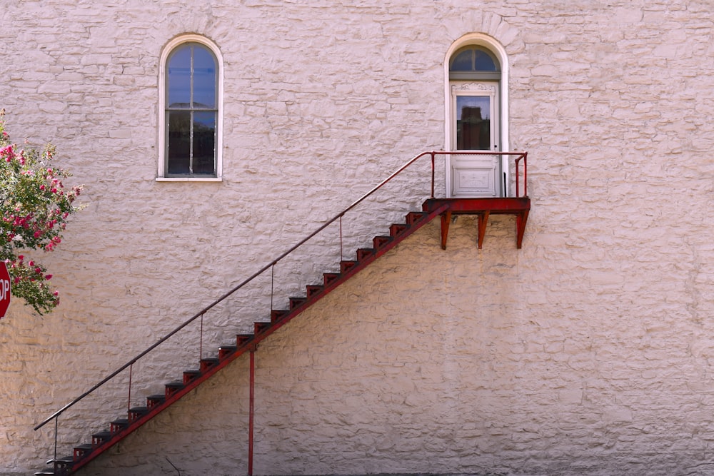 red and brown staircase near window