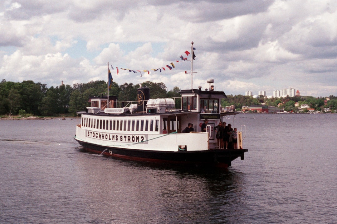 white and brown ship on sea under white clouds during daytime