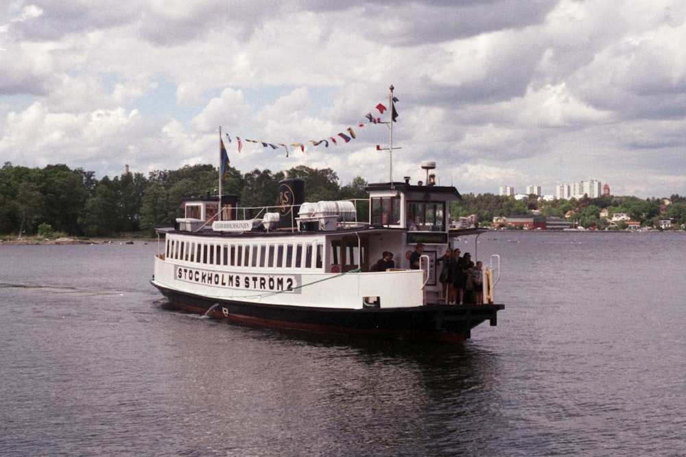 white and brown ship on sea under white clouds during daytime