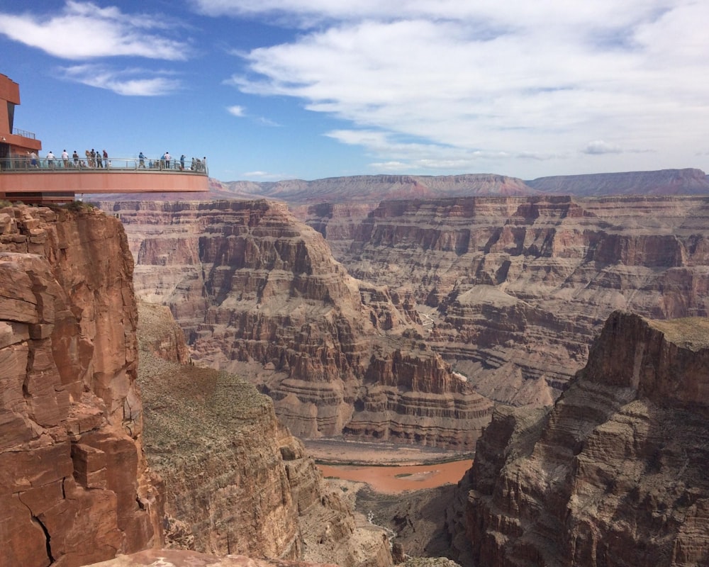 people standing on brown rock formation during daytime