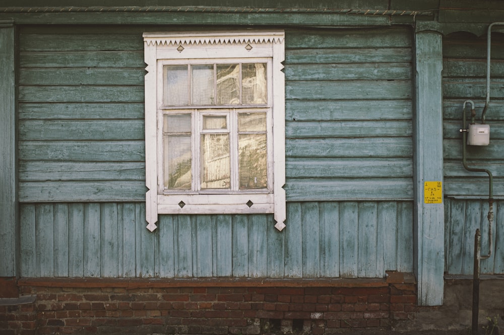 white wooden window frame on brick wall