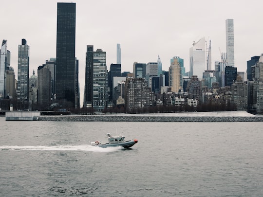 white and black boat on sea near city buildings during daytime in Franklin D. Roosevelt Four Freedoms Park United States