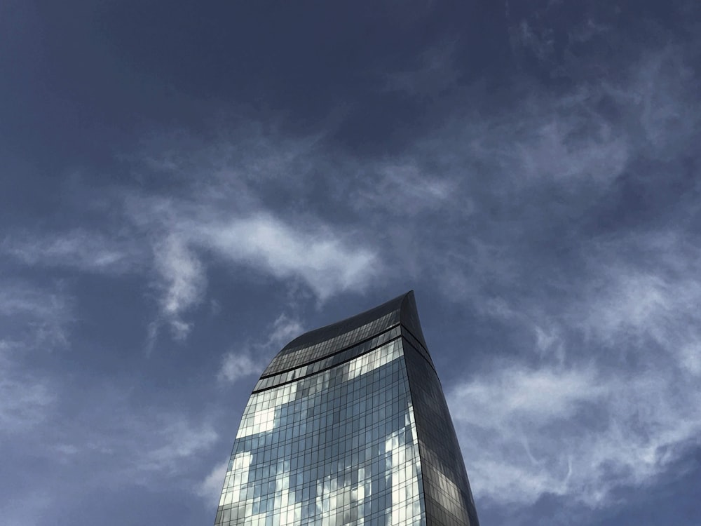 blue and white glass building under blue sky