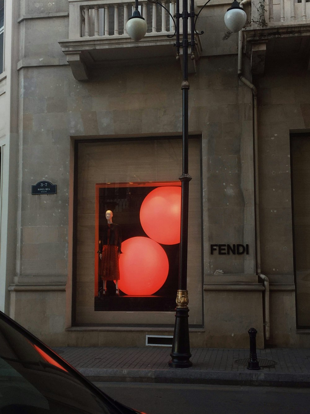 red pendant lamp turned on during daytime