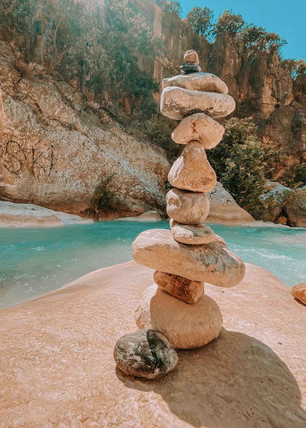 brown and gray rock formation near body of water during daytime