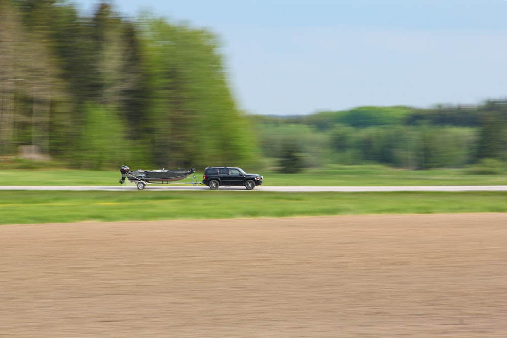 black coupe on brown field during daytime