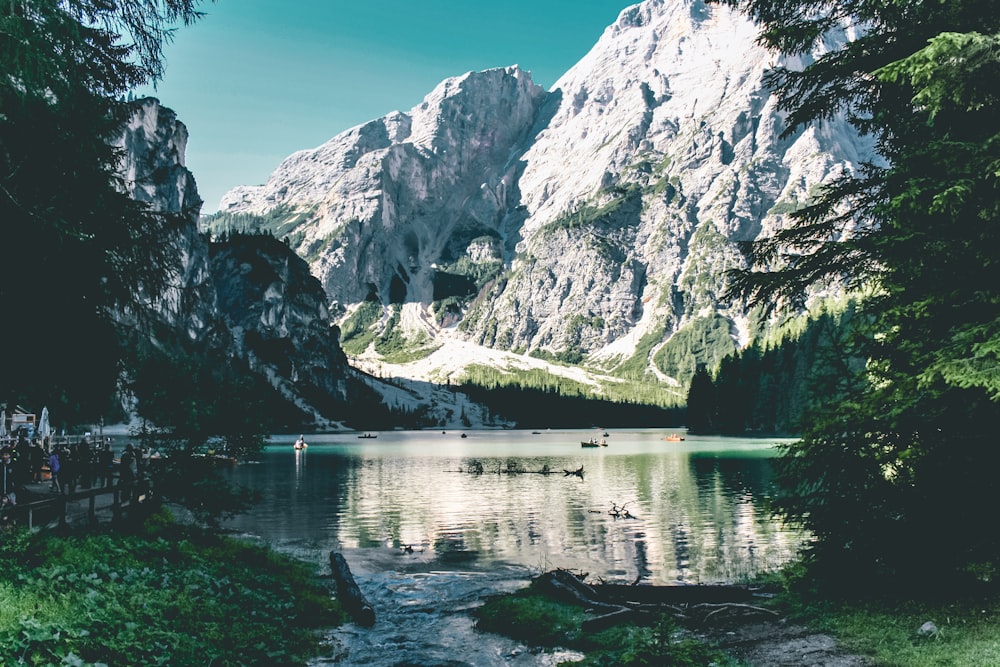 body of water near mountain during daytime