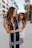 2 women standing on gray concrete floor during daytime
