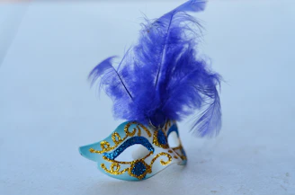 A whimsical fairy tale mask decorated with glitter and floral accents.