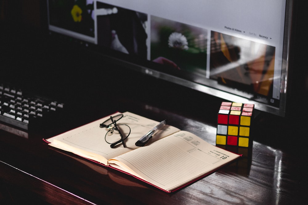 black framed eyeglasses on white paper