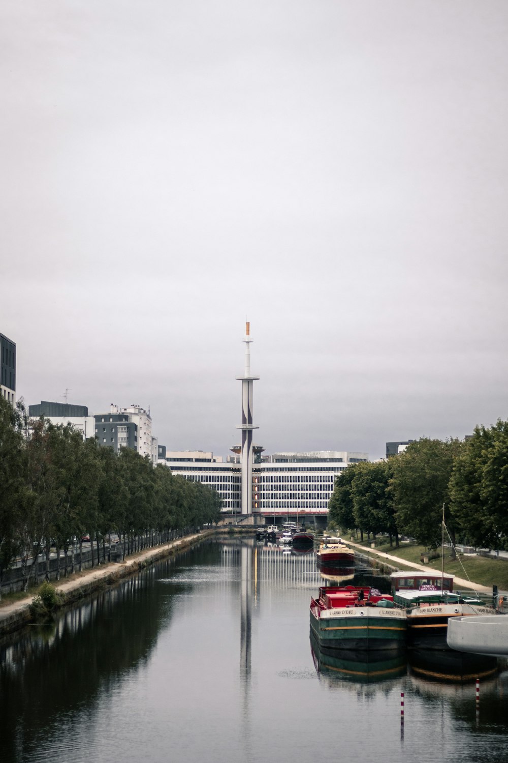 a waterway with several boats in it and buildings in the background