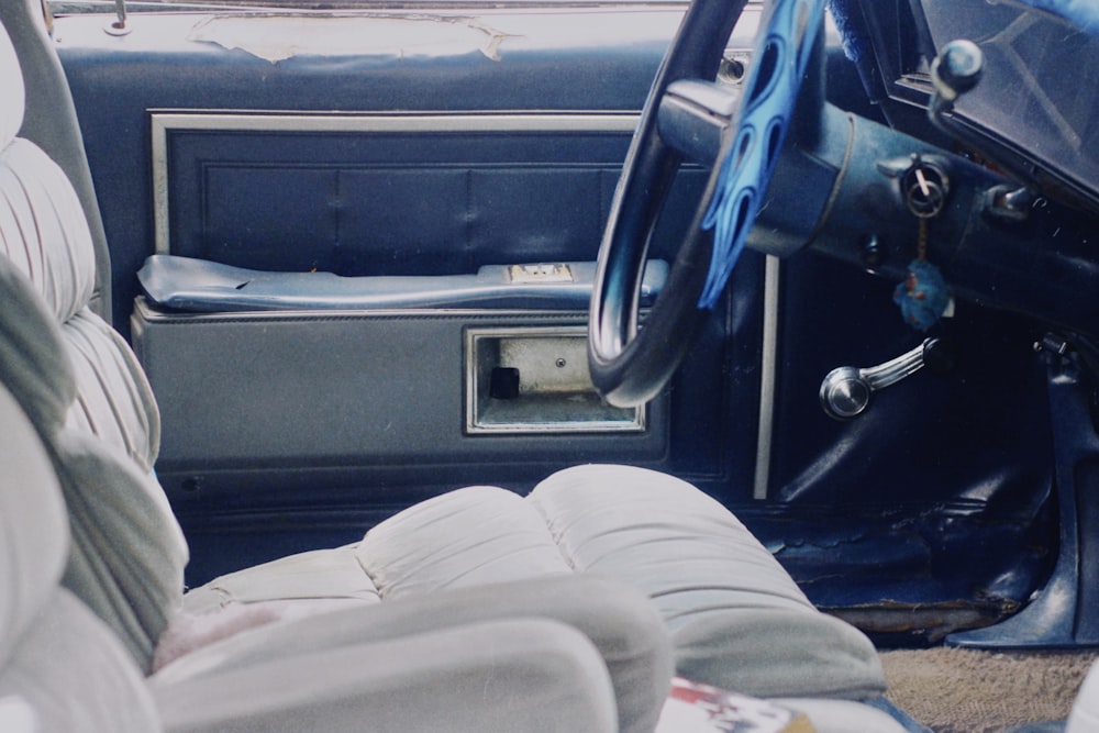 person in gray pants sitting on car seat