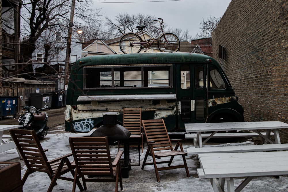 brown wooden table and chairs on snow covered ground