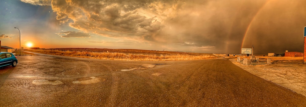 brown field under gray clouds