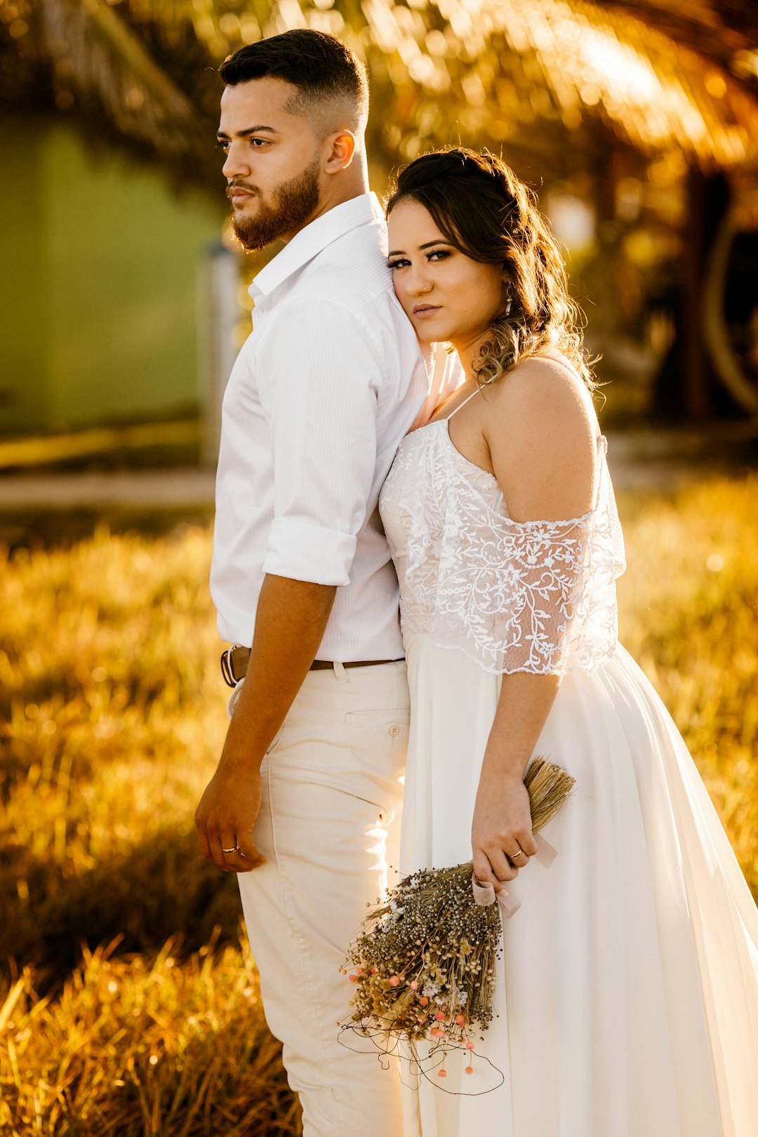 man in white dress shirt kissing woman in white dress