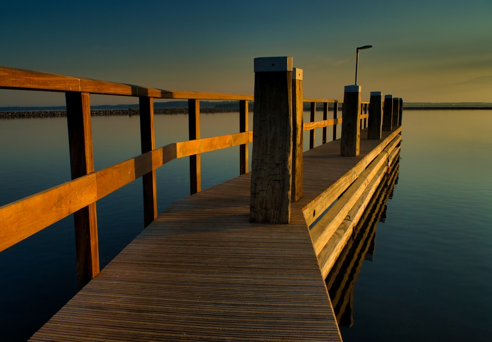 brown wooden dock on sea during daytime