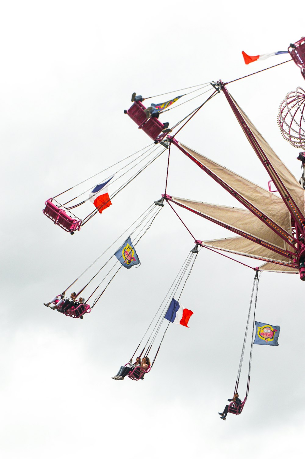 people riding on swing during daytime