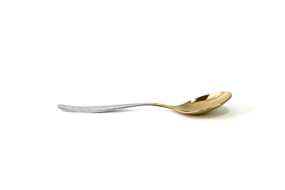 silver spoon on white surface