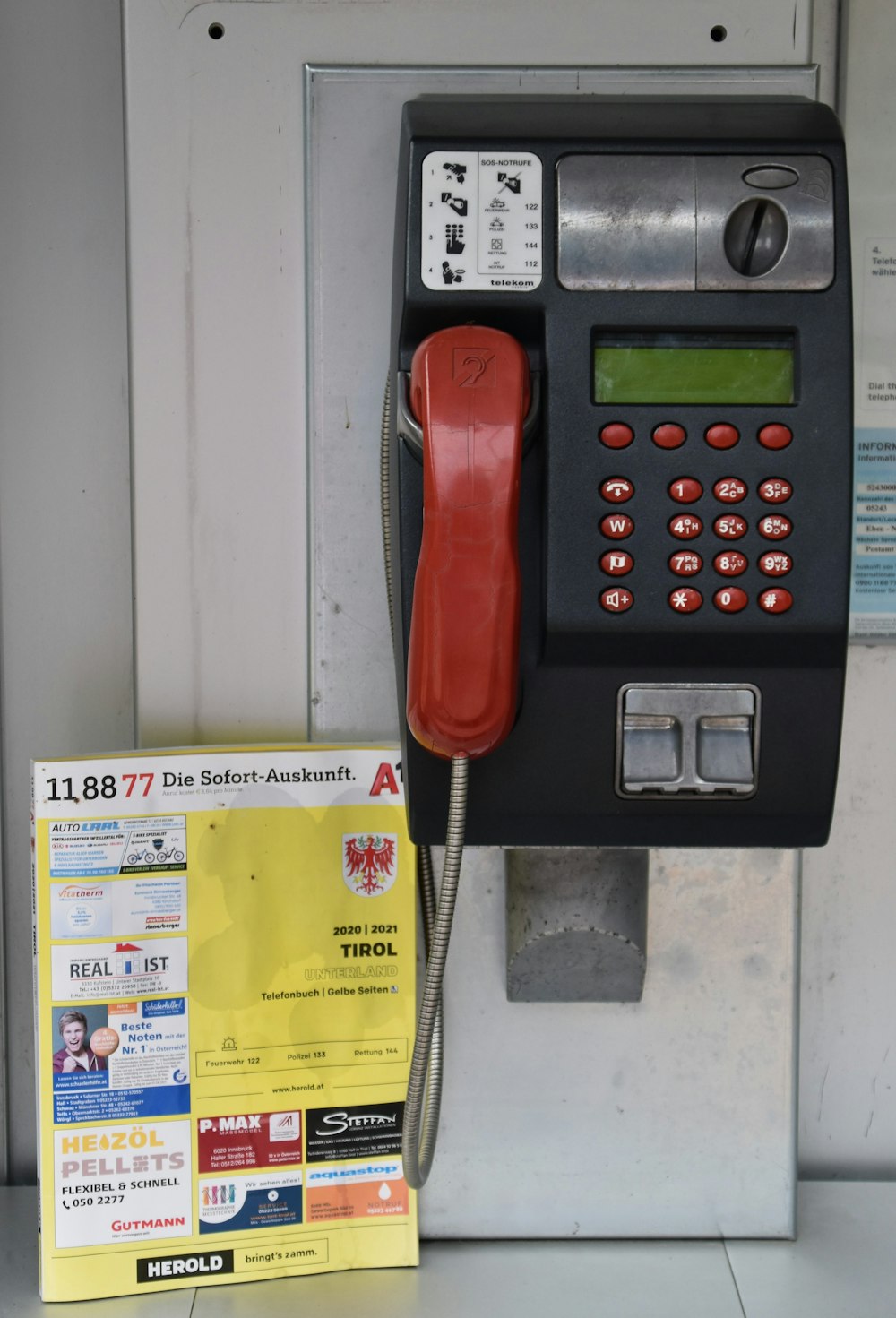 red telephone on yellow paper