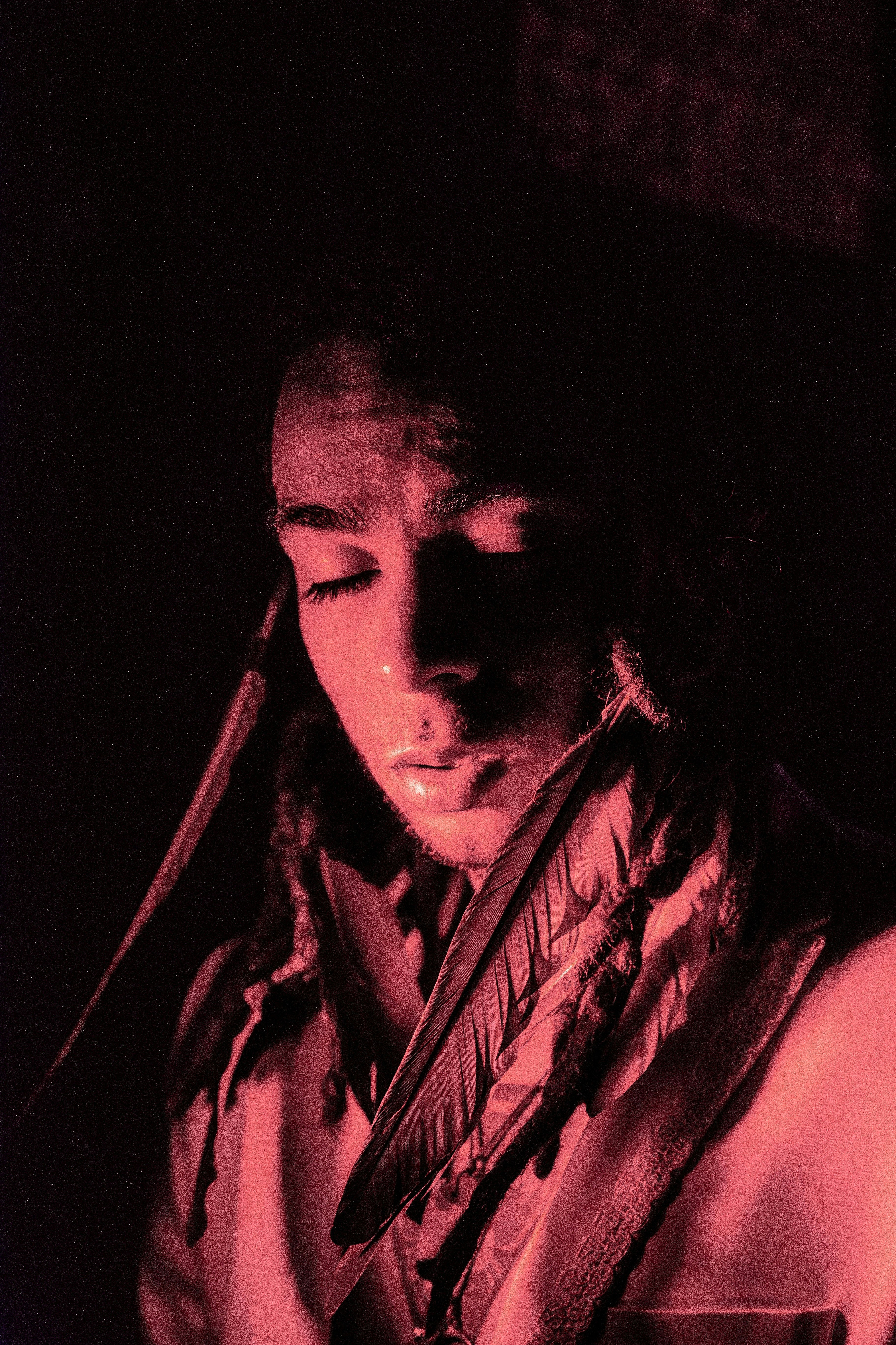 man in black shirt with brown and white guitar