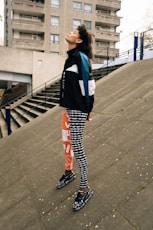 woman in black and white school uniform standing on gray concrete floor during daytime