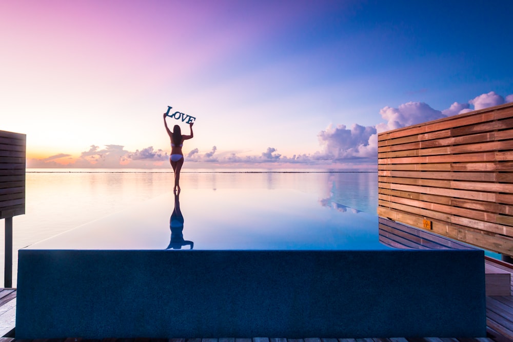 man in black shirt and pants standing on dock during daytime