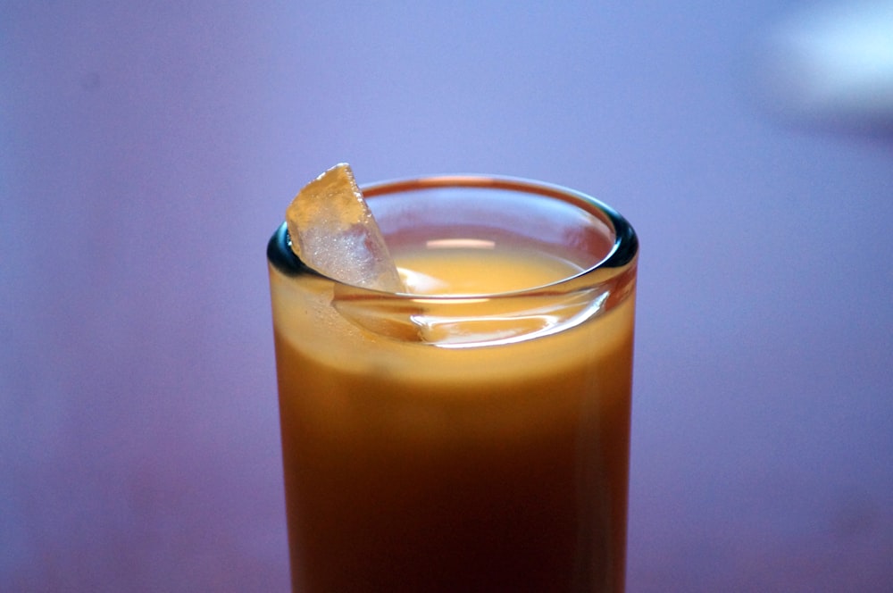 clear drinking glass with brown liquid