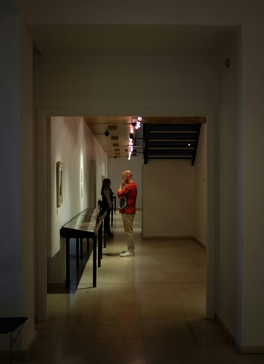 woman in red long sleeve shirt standing on hallway