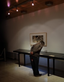 Artist carefully inspecting a fineart print under natural light.