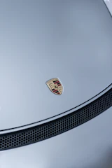 Detail shot of a perfectly applied protective clear wrap on a Porsche’s hood.