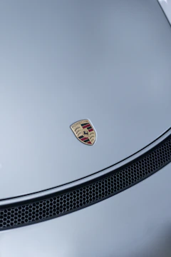 Side view of a silver Porsche showing upgraded sleek body panels and a refreshed front grille.