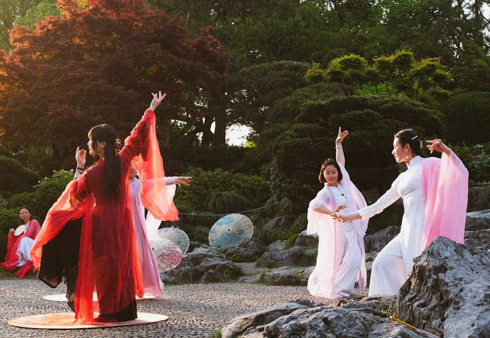 group of people in white robe standing on gray rock during daytime