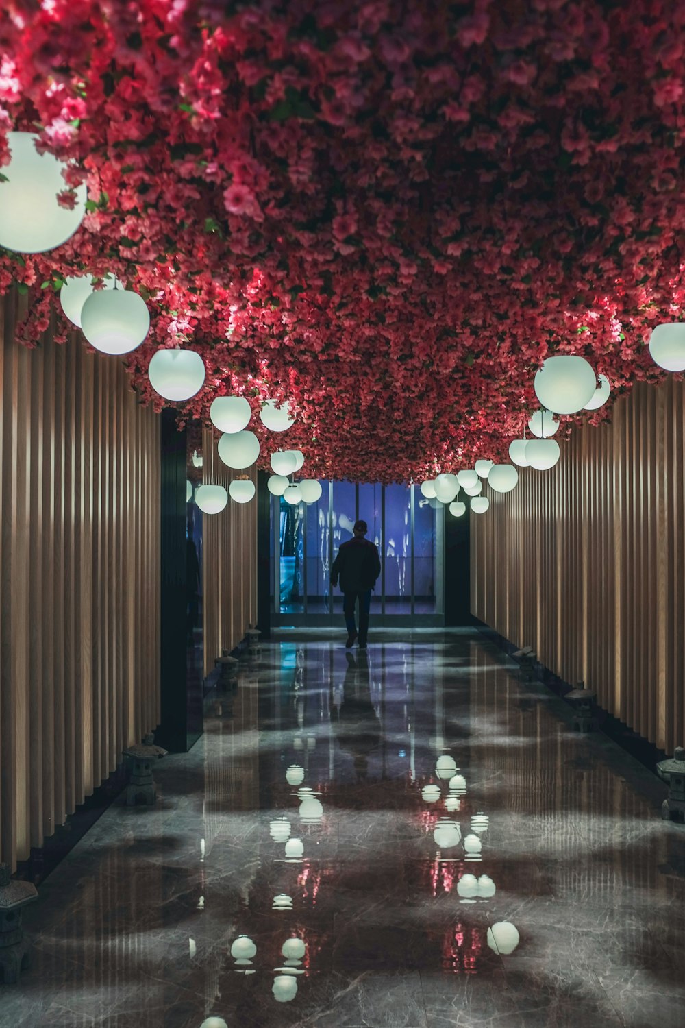 woman in black dress walking on hallway