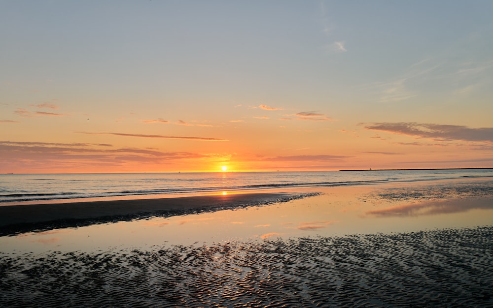 body of water during sunset