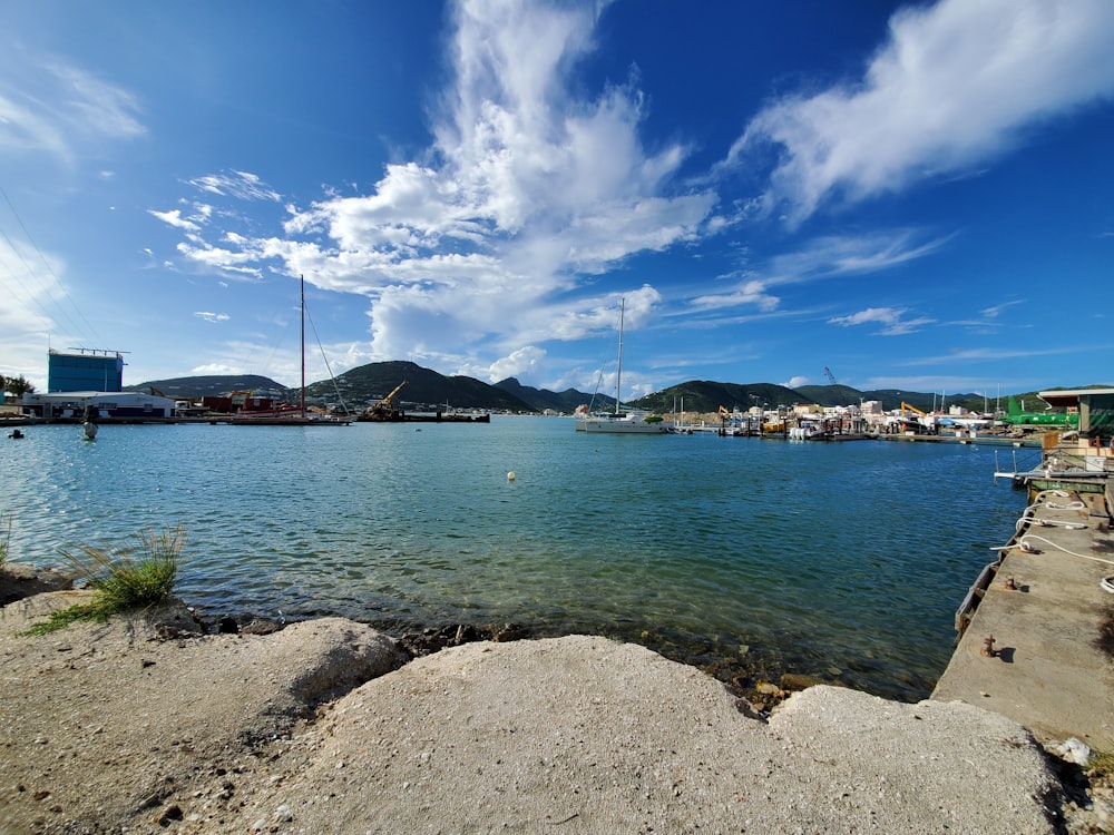 white boat on sea under blue sky during daytime