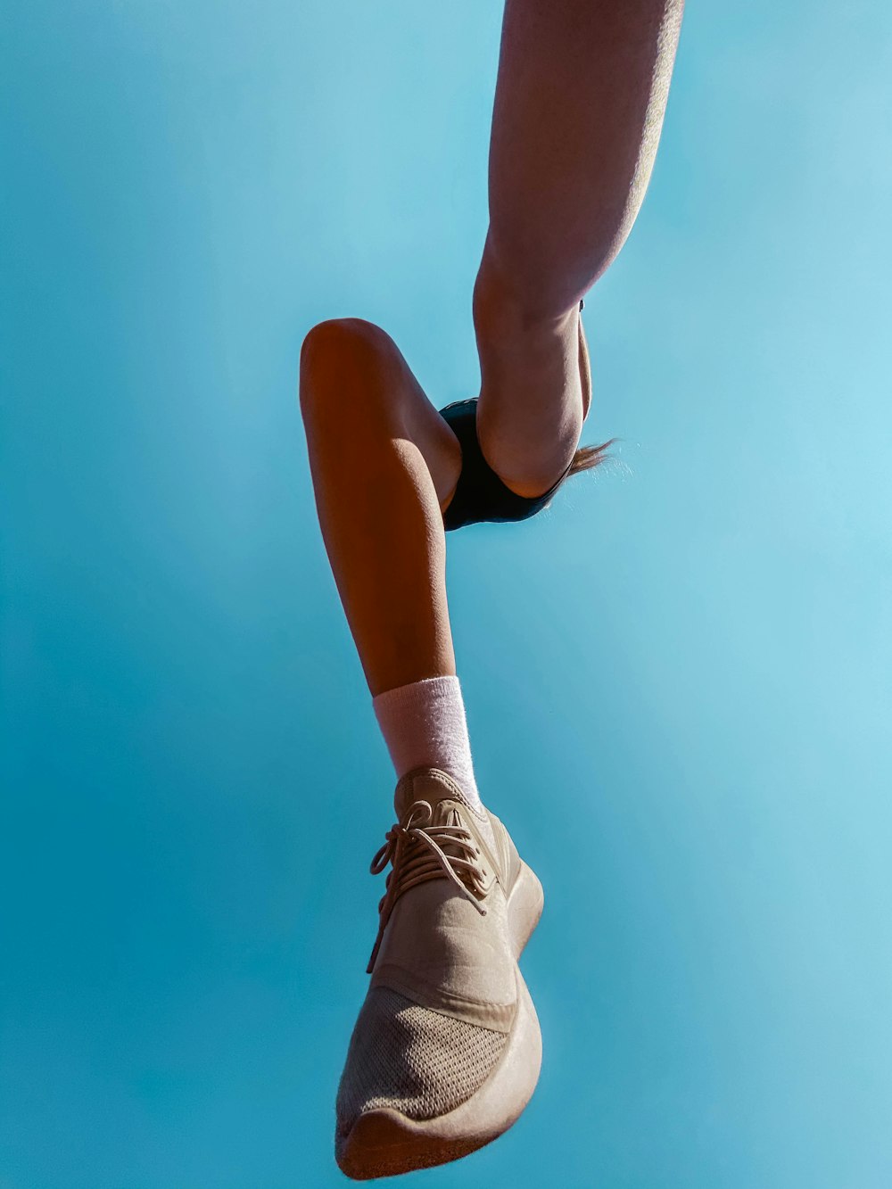 woman in brown low top sneakers