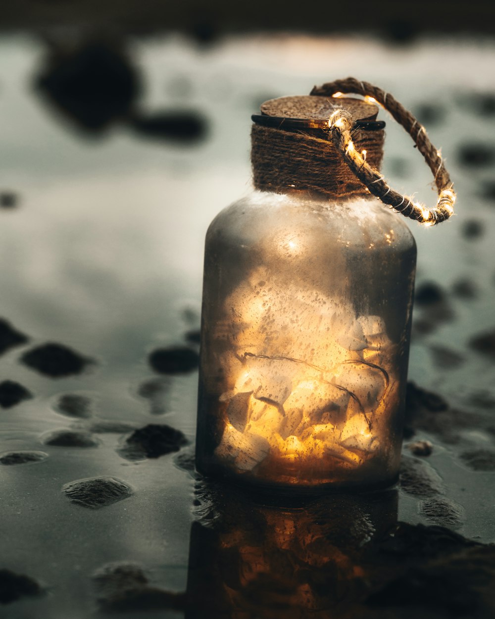 clear glass bottle with brown rope