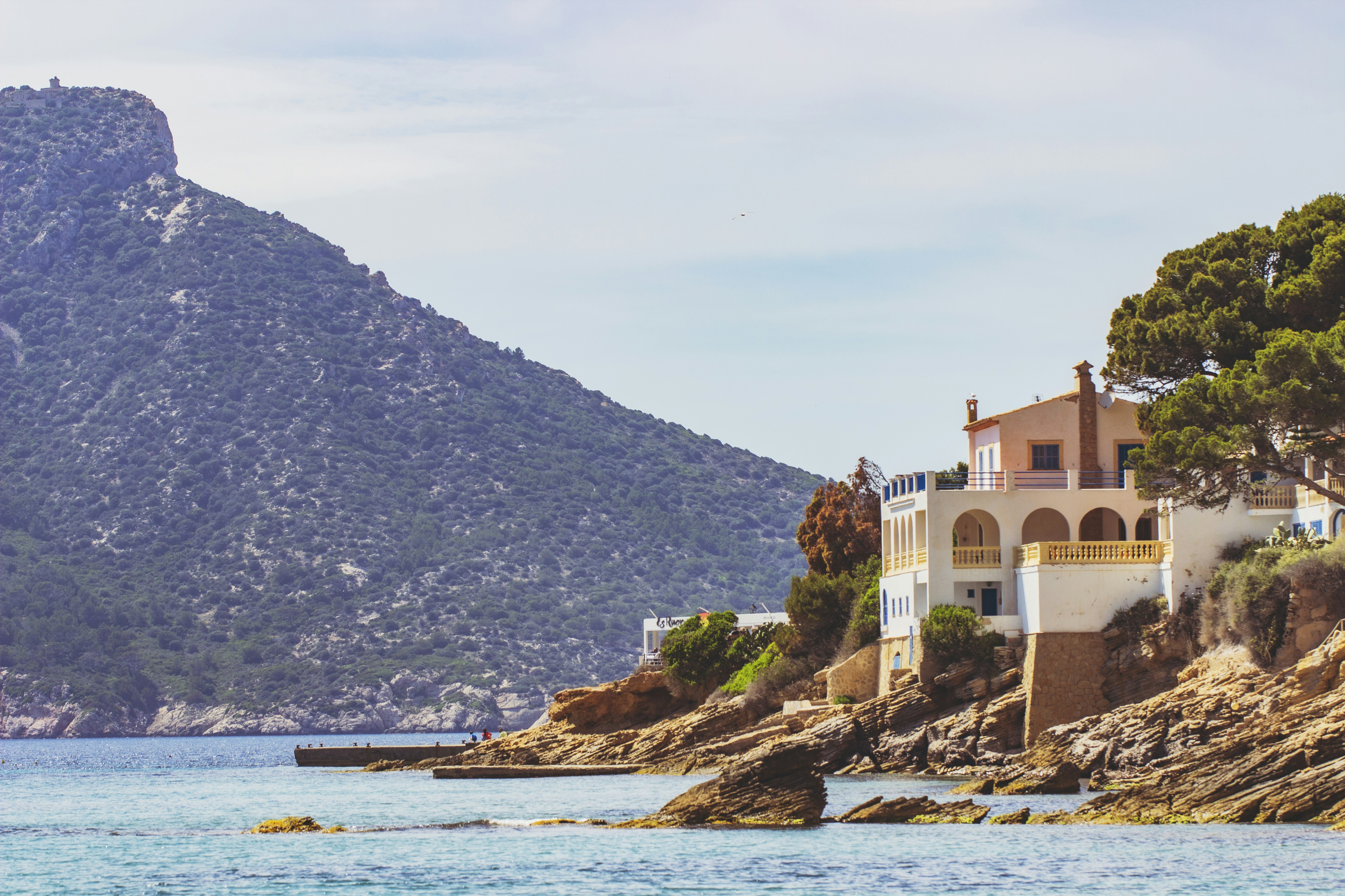 brown concrete building near body of water during daytime, 