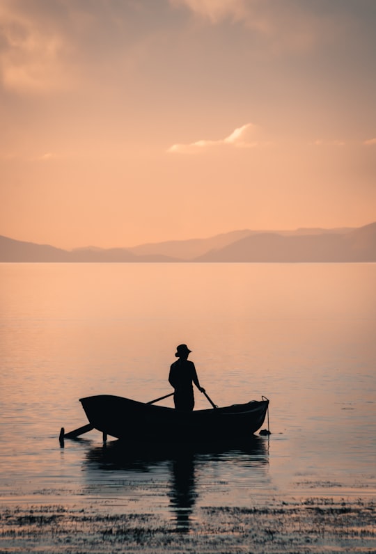 man in boat on lake during daytime in Isla del Sol Bolivia
