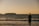 woman in black dress standing on seashore during sunset