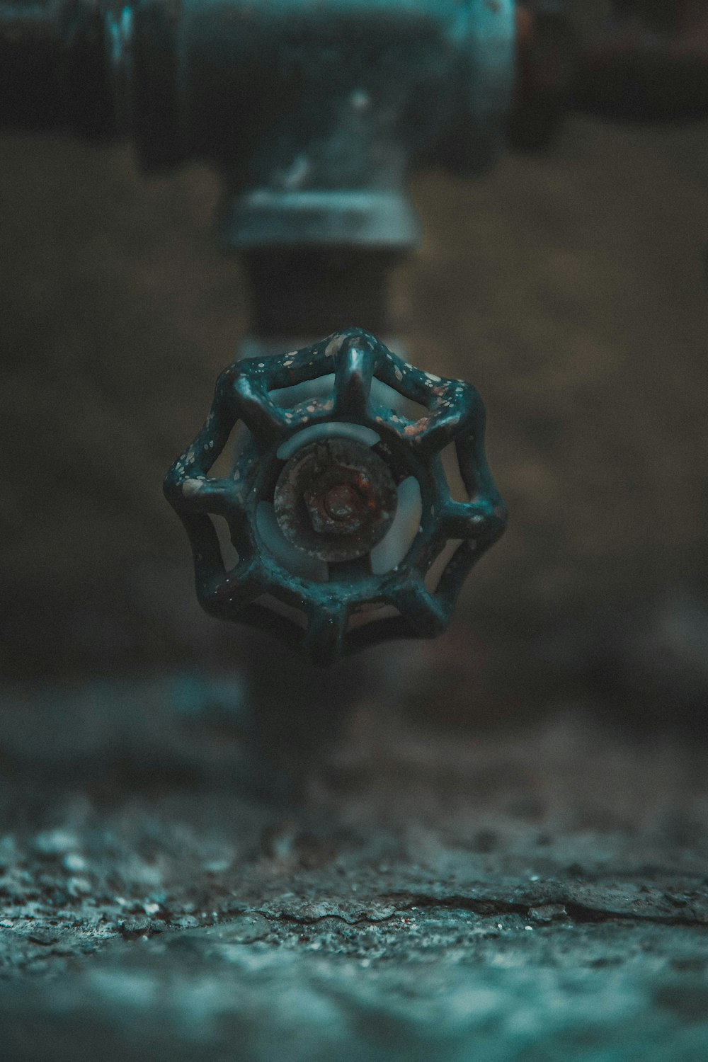 blue glass flower ornament on brown surface