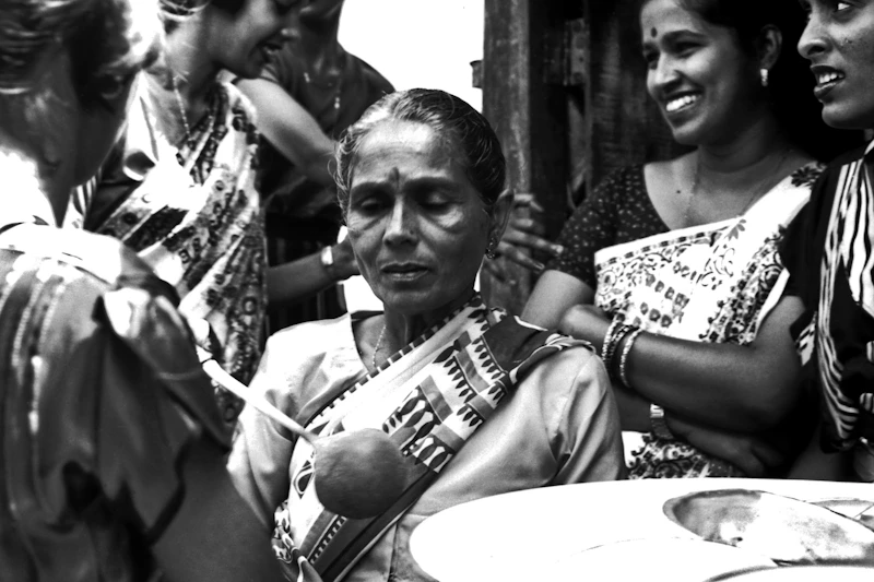Indian sugar mama reading a newspaper, a moment of reflection