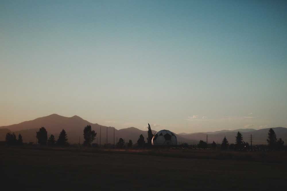 silhouette of trees and mountains during sunset