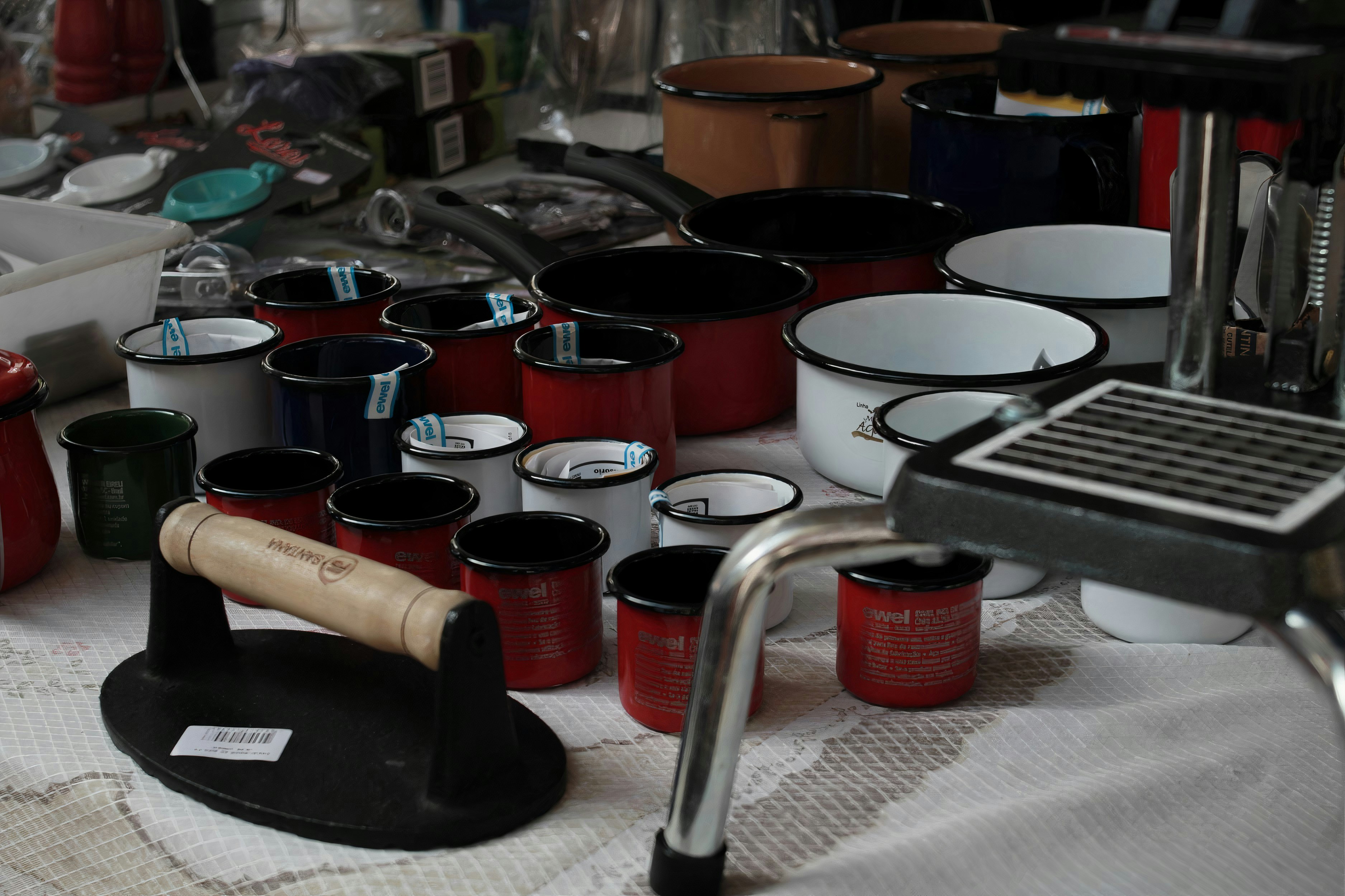 red ceramic mugs on stainless steel rack