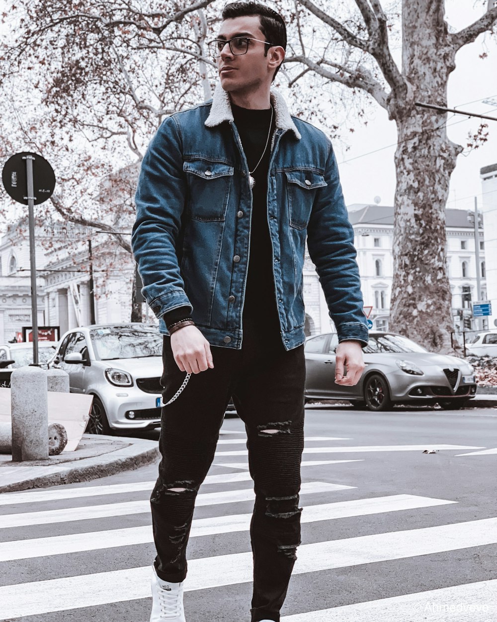 man in blue zip up jacket standing on pedestrian lane during daytime