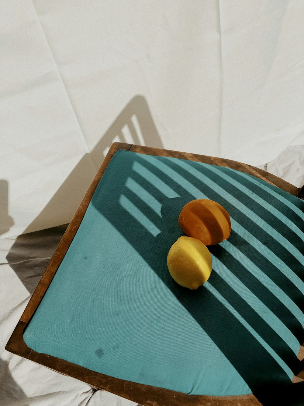 yellow round fruit on blue and white striped textile