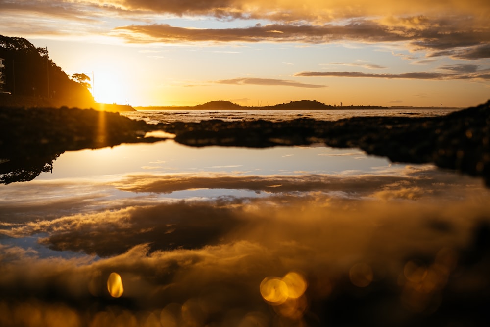 body of water during sunset