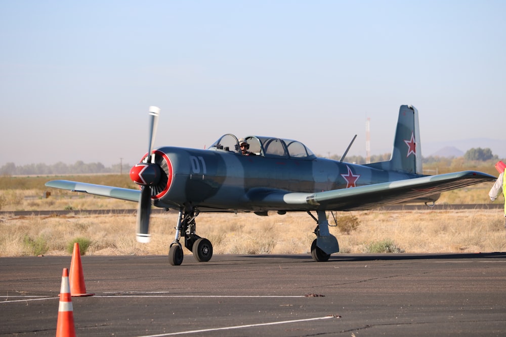 blue and red jet plane on gray concrete road during daytime