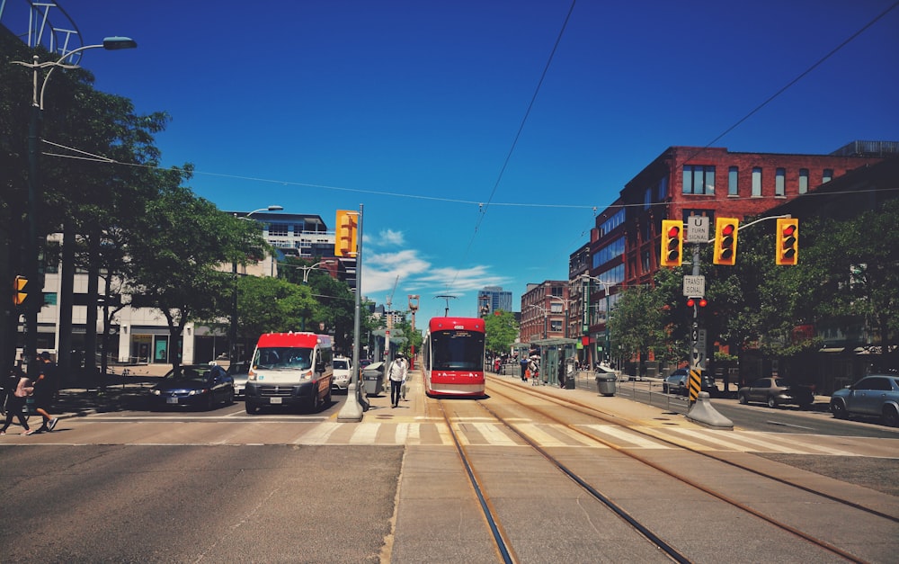 red and white bus on road during daytime