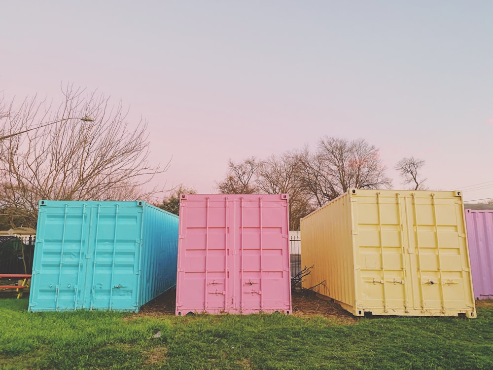 blue and brown storage boxes on green grass field